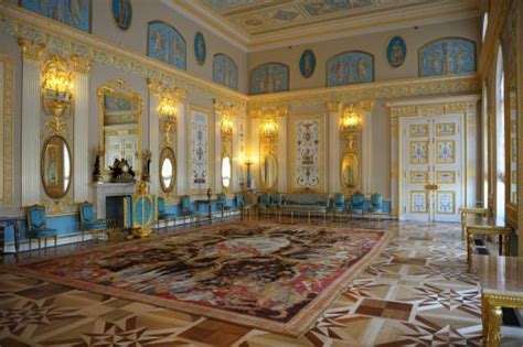 an ornately decorated room with blue chairs and gold trimming on the ...