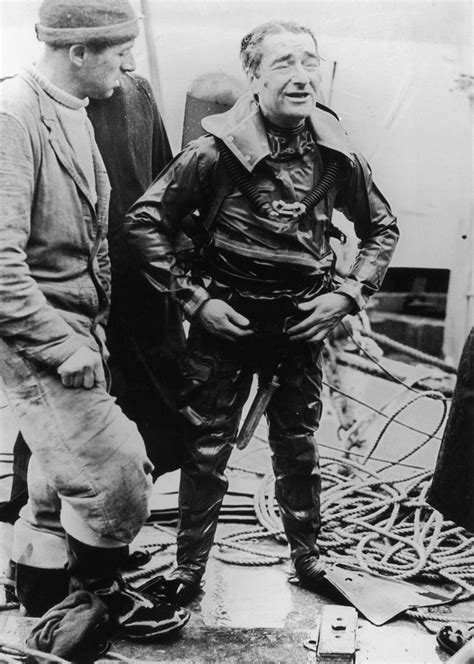 Royal Navy frogman Lionel 'Buster' Crabb (1909 - 1956) prepares for a dive in Tobermory Bay, on ...