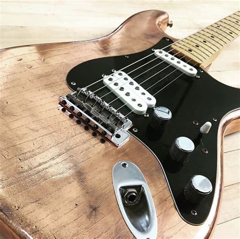 an electric guitar sitting on top of a wooden table