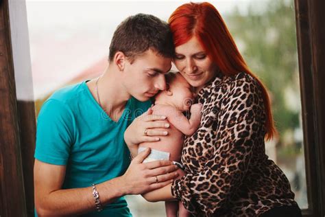 Happy Parents with Their Newborn Baby Stock Photo - Image of cute, cradling: 97672712