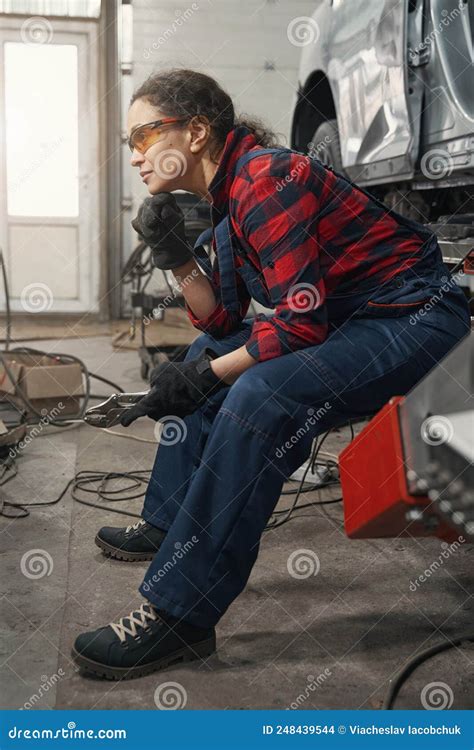 Female Auto Mechanic with Tool Sitting in Car Garage Stock Photo - Image of machinery, human ...