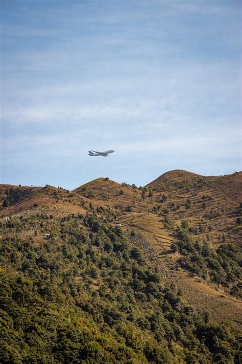 Passenger Airplane Flying over Mountains · Free Stock Photo