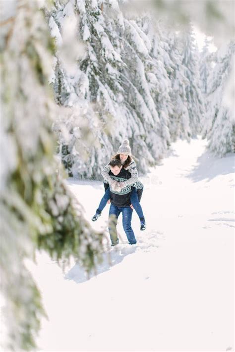 Winter Fun Couple Playful Together during Winter Holidays Vacation Outside in Snow Forest. Stock ...