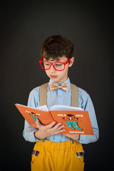 Little boy in glasses reading book · Free Stock Photo