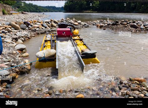 Suction dredge mining alluvial gold on an Amazonian riverbank in Ecuador Stock Photo - Alamy