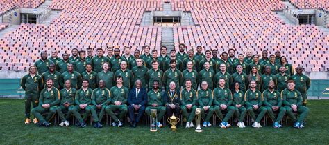 The Springbok squad and management staff with the trophies that they ...