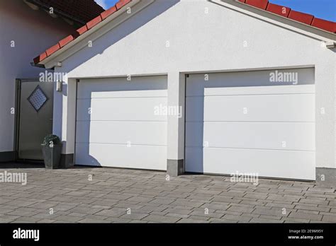 Modern white garage door (sectional door Stock Photo - Alamy