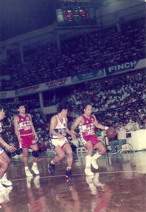 Robert Jaworski (Ginebra) drives for the ball with Alvin Patrimonio ...