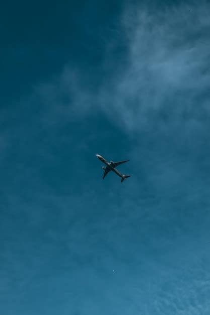 Premium Photo | Photo of a plane flying in blue sky