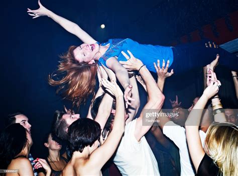 Woman Crowd Surfing High-Res Stock Photo - Getty Images