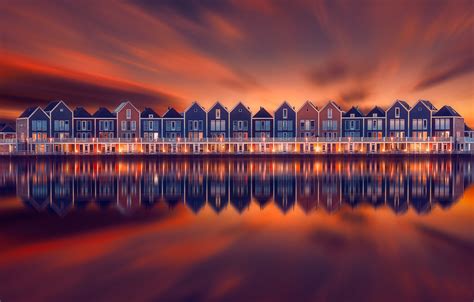 Houten, Holland - The rainbow colored houses of the Dutch area Houten and the lake Rietplas at ...