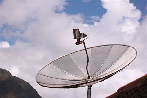 Satellite Dish Against Blue Sky and Clouds · Free Stock Photo