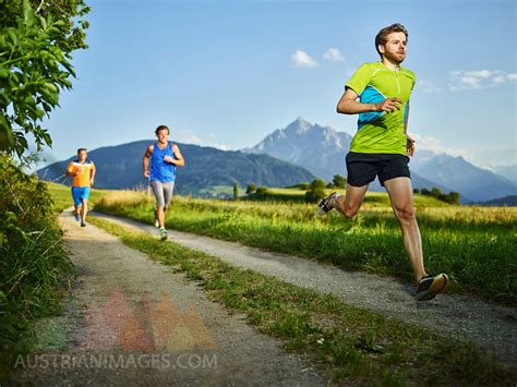 austrianimages.com | Athletes running on field path at sunset