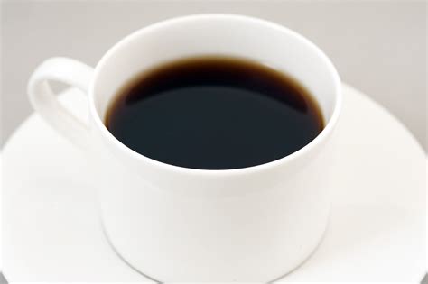 Black energizing coffee served in a white cup - Free Stock Image