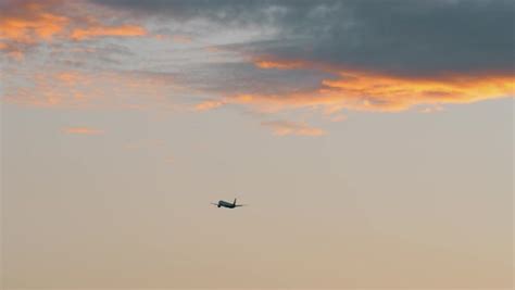 Airplane flying into the distance. Jet view in the sky with sunset clouds - Stock Video Footage ...