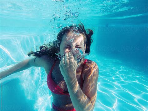 Woman in bikini holding her breath underwater by Jacob Lund - Stocksy United