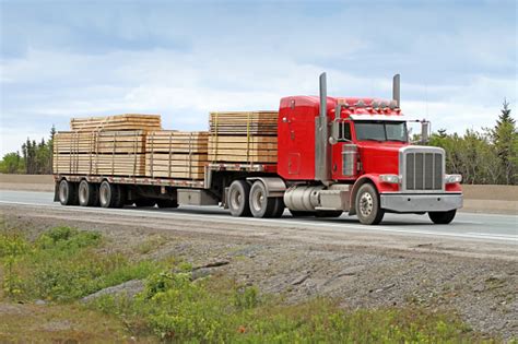 Semi Flatbed Truck Hauling A Load Of Lumber To A Construction Site Stock Photo - Download Image ...