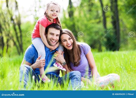 Young Family Bonding in Park Stock Image - Image of love, lawn: 40699439