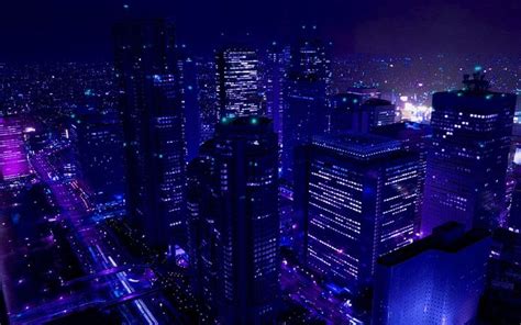 the city is lit up at night with purple lights and skyscrapers in the background