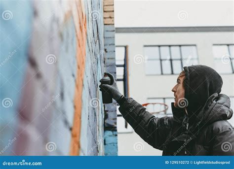 Man Painting Colorful Graffiti Stock Photo - Image of wall, spray: 129510272