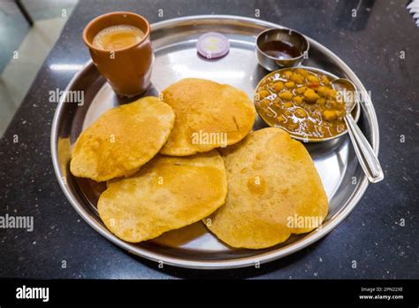 Chole puri, with tea, Mumbai, India Stock Photo - Alamy