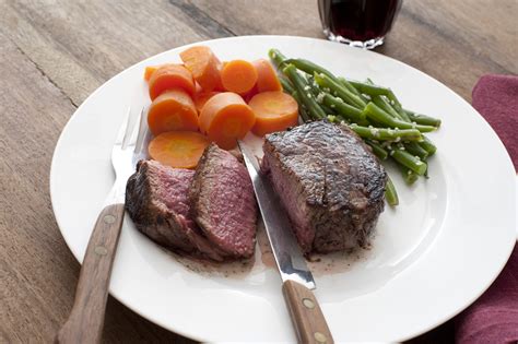 supper of medium rare steak with vegetables - Free Stock Image