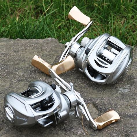 two fishing reels sitting on top of a rock