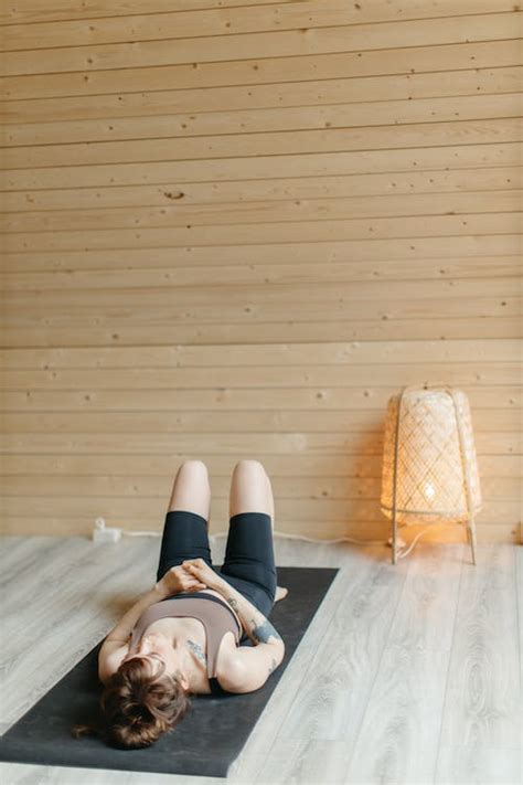 Person Lying on Black Yoga Mat · Free Stock Photo