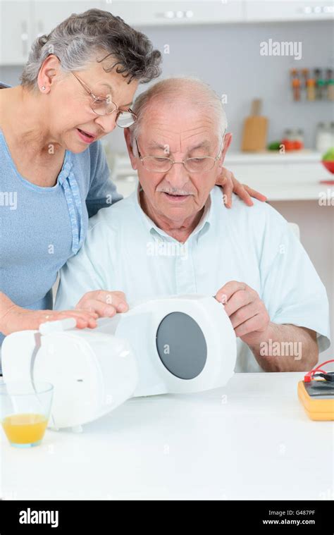 elderly couple with coffee maker Stock Photo - Alamy