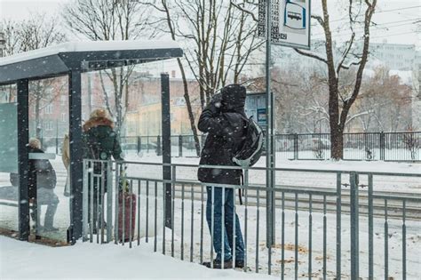 Premium Photo | People at the bus stop in snowy winter