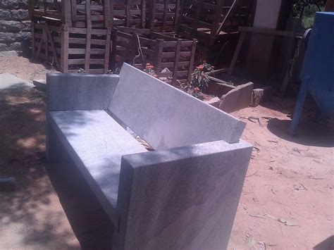 a concrete bench sitting in the middle of a yard
