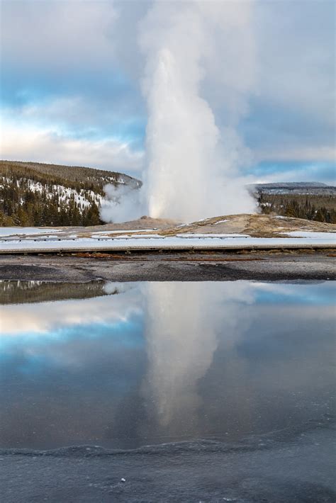 Old Faithful eruption reflected in a puddle | NPS / Jacob W ...