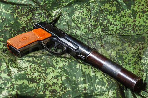 Weathered generic russian soviet semi-automatic 9mm silenced pistol on ...