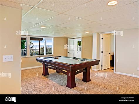 Pool table in game room Stock Photo - Alamy