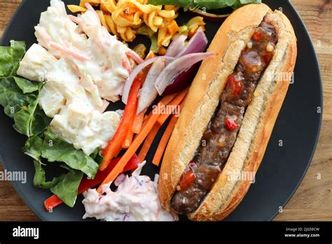 Boerewors roll with salads including coleslaw and potato salad Stock Photo - Alamy