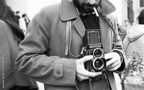 Close-up of Hipster man with the vintage camera. Photographer with a famous retro camera ...