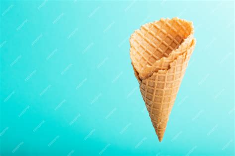 Premium Photo | Waffle cone over blue background. Strawberry or raspberry flavor Sweet dessert ...