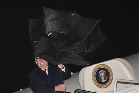 Watch Trump struggle and fail to control unruly umbrella as metaphor for his presidency.