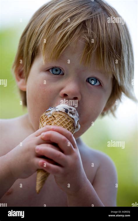 Little boy eating ice cream cone Stock Photo - Alamy