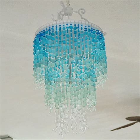 a chandelier hanging from the ceiling with blue and green beaded beads on it