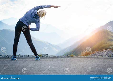 Athlete at the Top of the Mountain Doing Workout. Stock Photo - Image ...