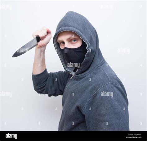 masked man holding knife Stock Photo - Alamy