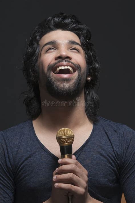 Singer Holding A Mike And Singing Stock Image - Image of 2024, singer: 36256297