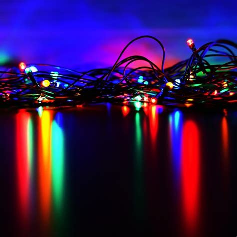 Premium Photo | Christmas lights on black background with copy space colored reflecting surface