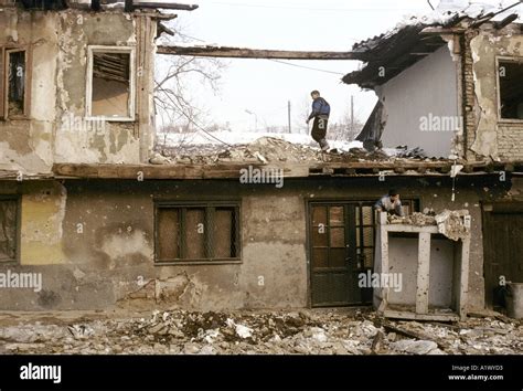 TWO BOYS PLAYING AMONGST THE RUBBLE OF WAR DAMAGED BUILDINGS SARAJEVO WINTER 1994 Stock Photo ...