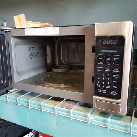 LG STAINLESS AND BLACK MICROWAVE - Big Valley Auction