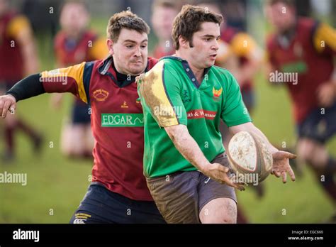 Rugby player passing ball Stock Photo - Alamy