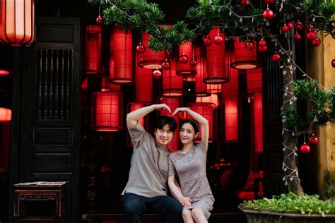 A Couple Posing in Front of hanging Chinese Lanterns · Free Stock Photo