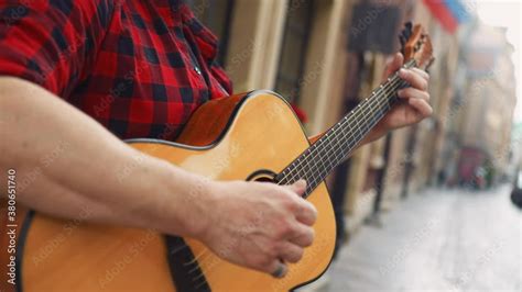 Relaxed guitarist playing slow chords on the streets, close up shot Stock ビデオ | Adobe Stock