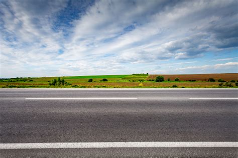 Country Road With Field On Horizon Side View Stock Photo - Download ...